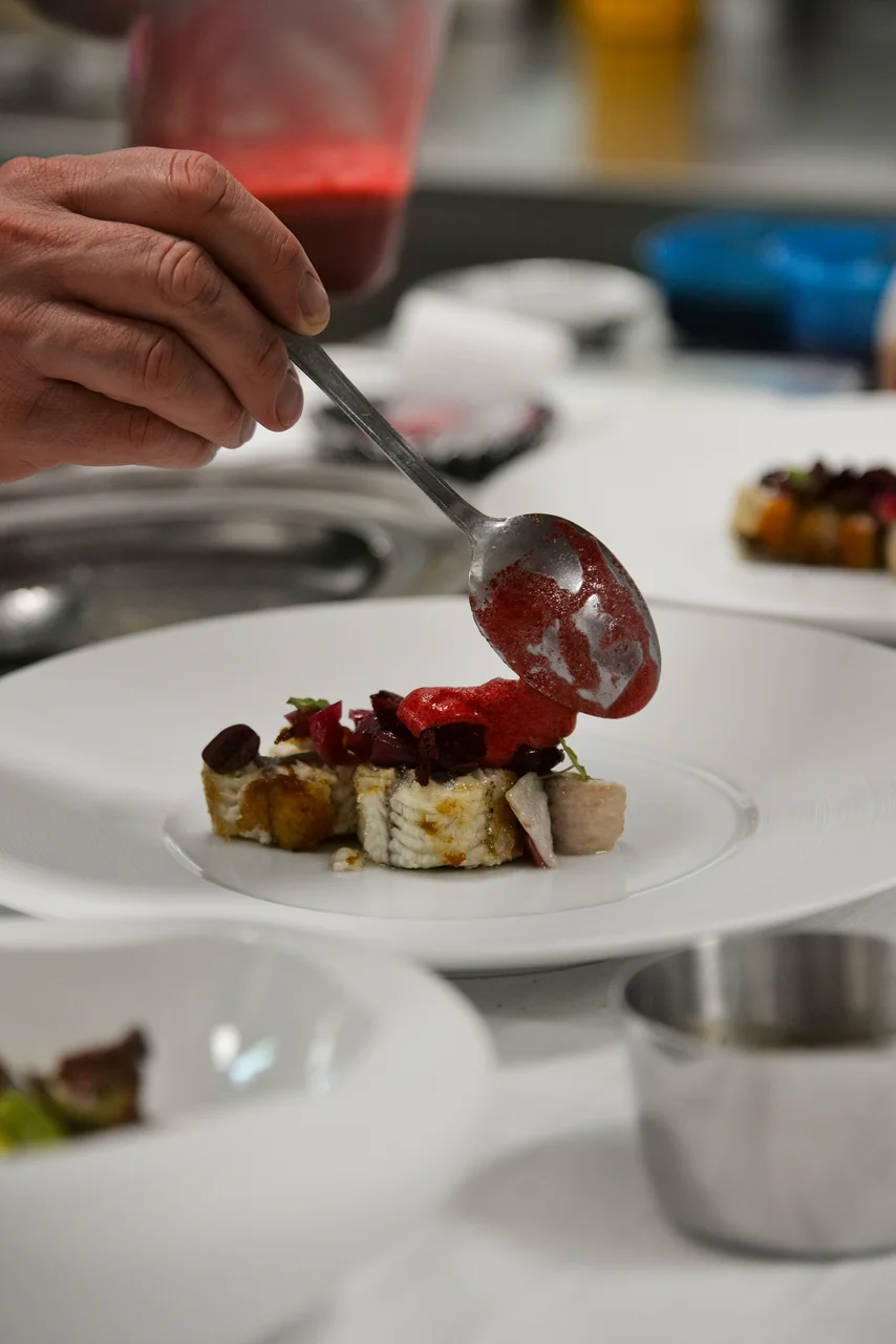 Chef preparing a seasonal dish with local ingredients